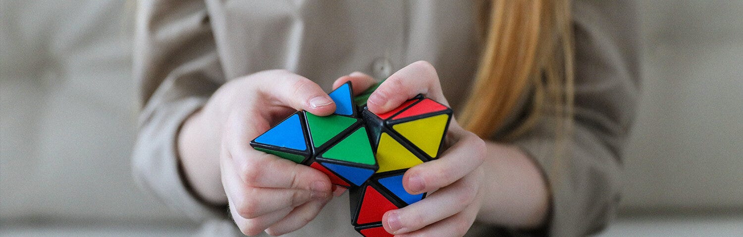 Person plays with Rubix cube