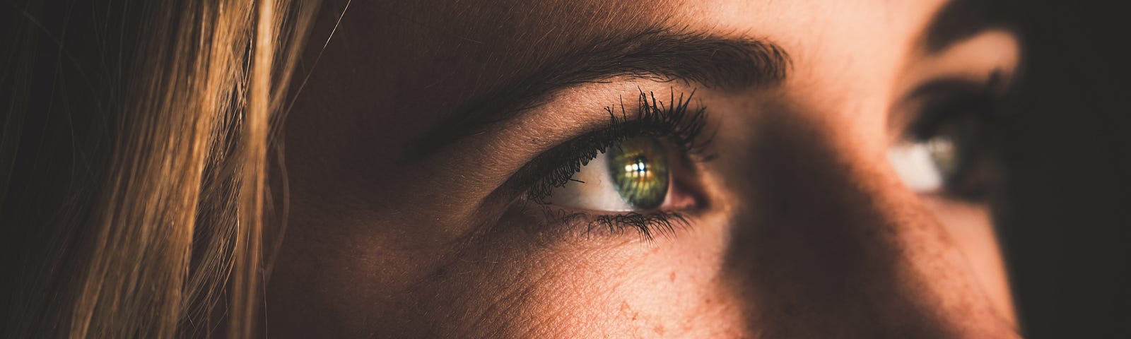 A young blonde woman gazes to the right. She is seen in an extreme closeup of her face. The COVID19 variant XBB.1.16 (ARCTURUS) is on the rise worldwide. The new variant is highly contagious. Today we look at the new COVID variant and one striking symptom you should know about.
