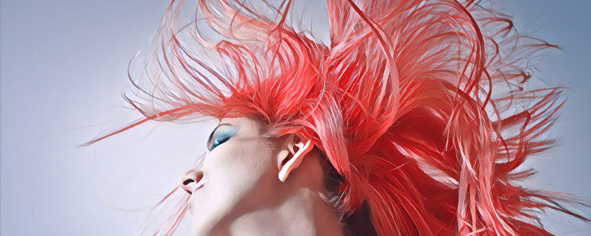 A girl with pink hair shaking her head