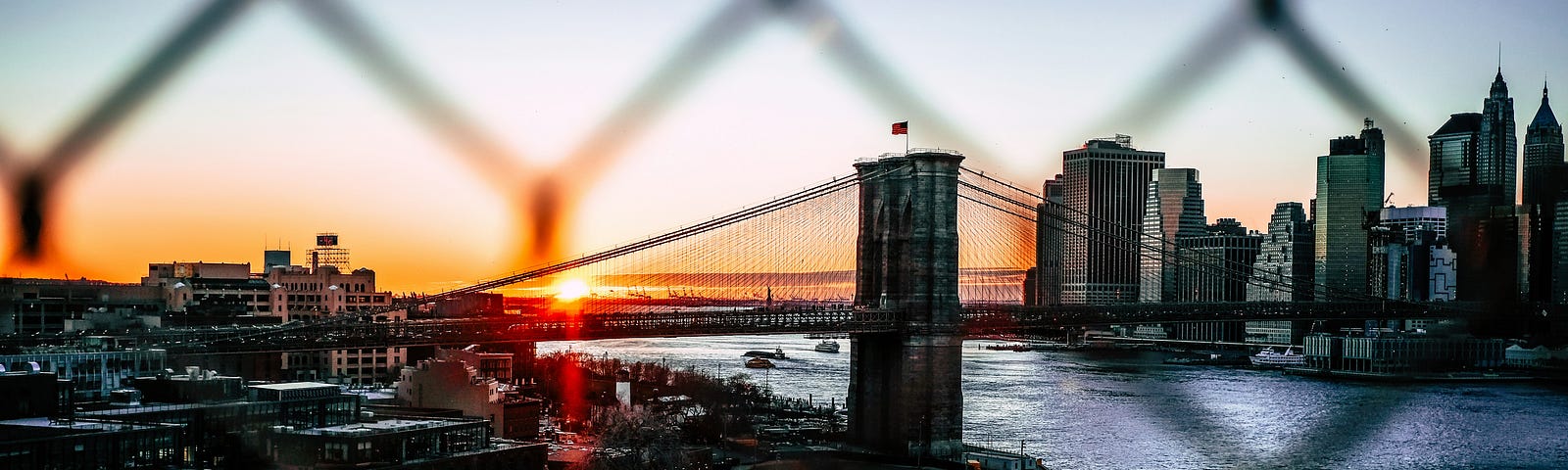 view of NYC with bridge and sunset in background