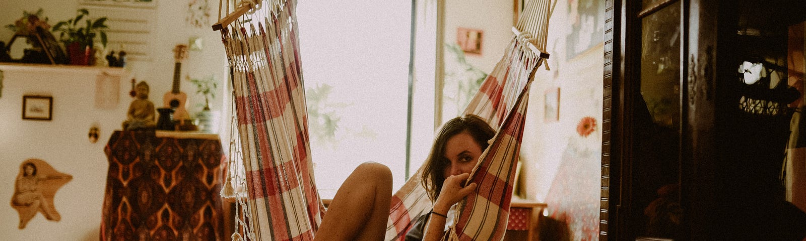 A woman is seen in a boho apartment.