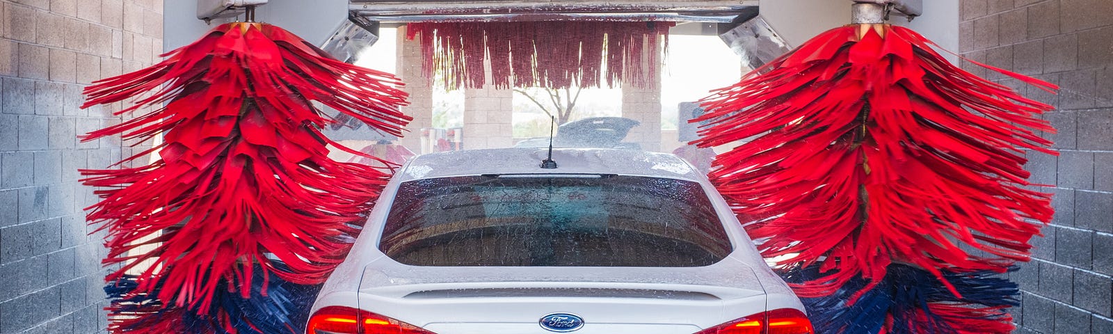 A car embarking on the automatic car wash journey.