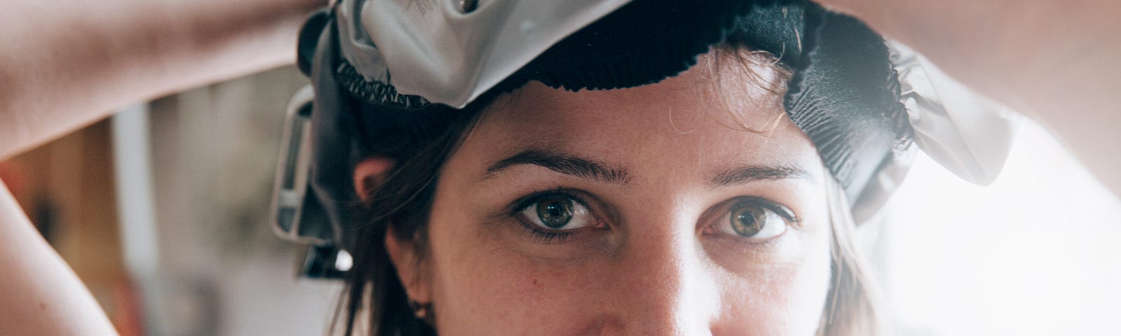 Photo of a woman maker lifting a welding helmet to smile at the camera. Most crafters and makers on handmade marketplaces are women.