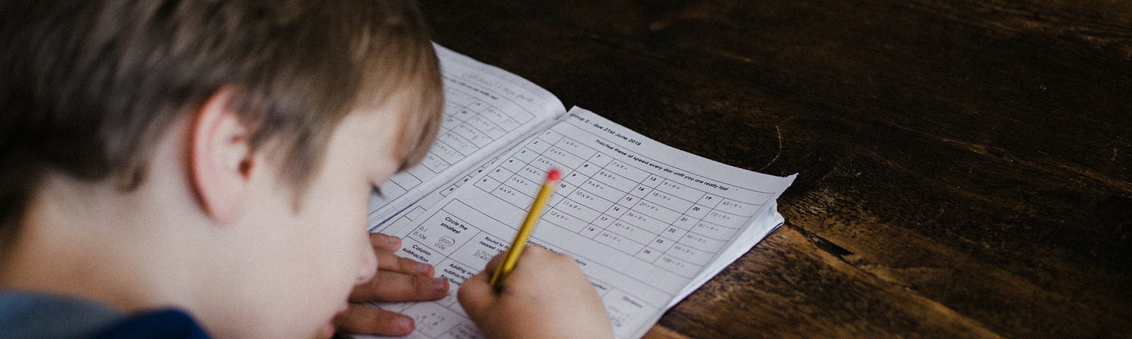 Child writing on activity book
