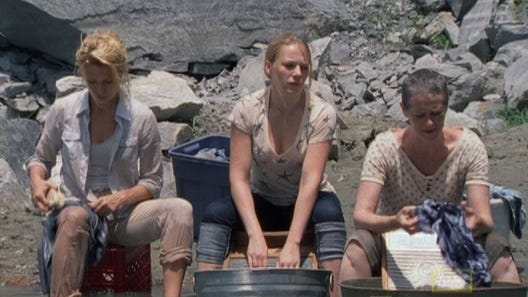 Women of The Walking Dead Season 1 washing clothes.