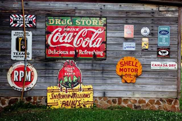 drug store drink coca cola signage on gray wooden wall will different types of advertising