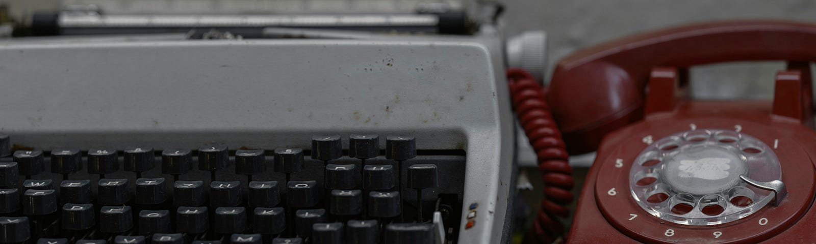 Old typewriter and phone