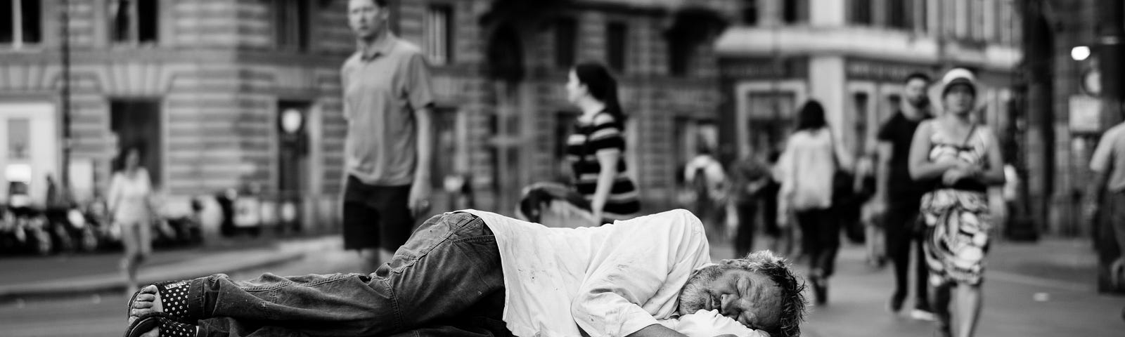 picture of homeless man lying on a bench