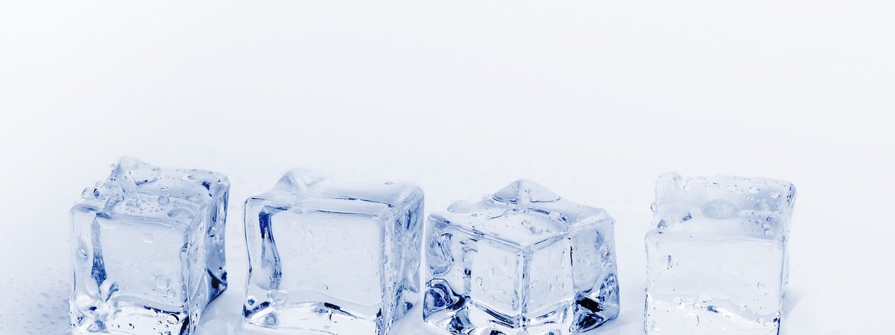 Four ice cubes on whit background.