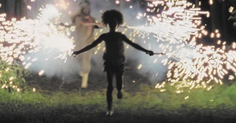 A still frame from the movie Beasts of the Southern Wild showing Hushpuppy running with sparklers.