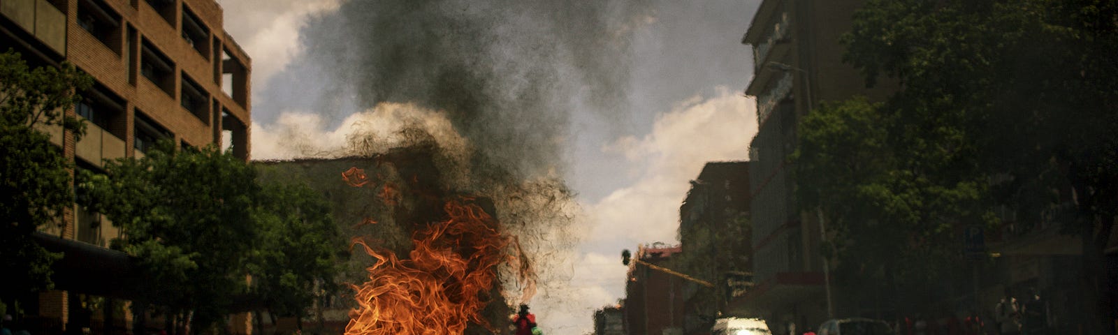 Burning debris in a city street.