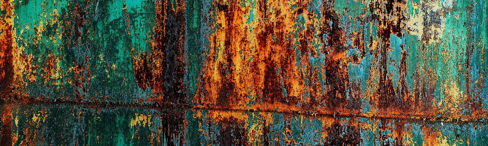 Rusted metal with green, red, and brown tones