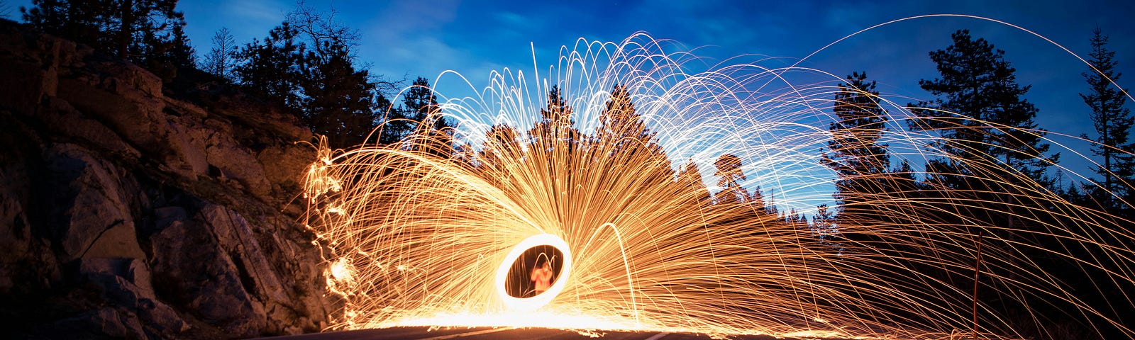 Numerous golden sparks on the road emanating from an object in the center