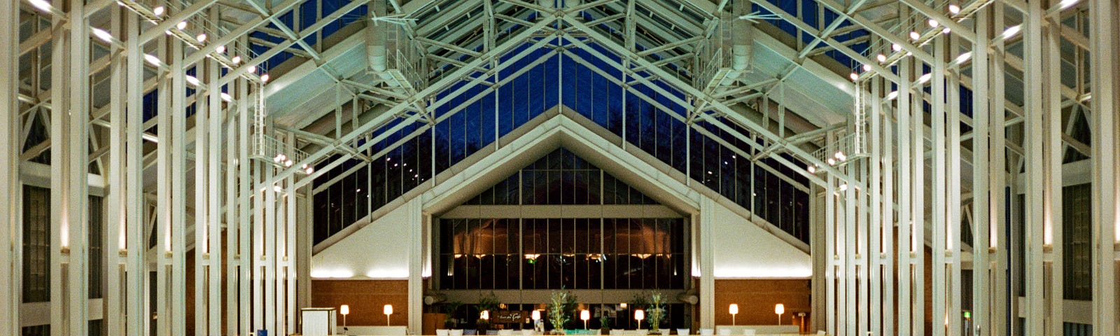 A massive indoor pool with many people swimming.