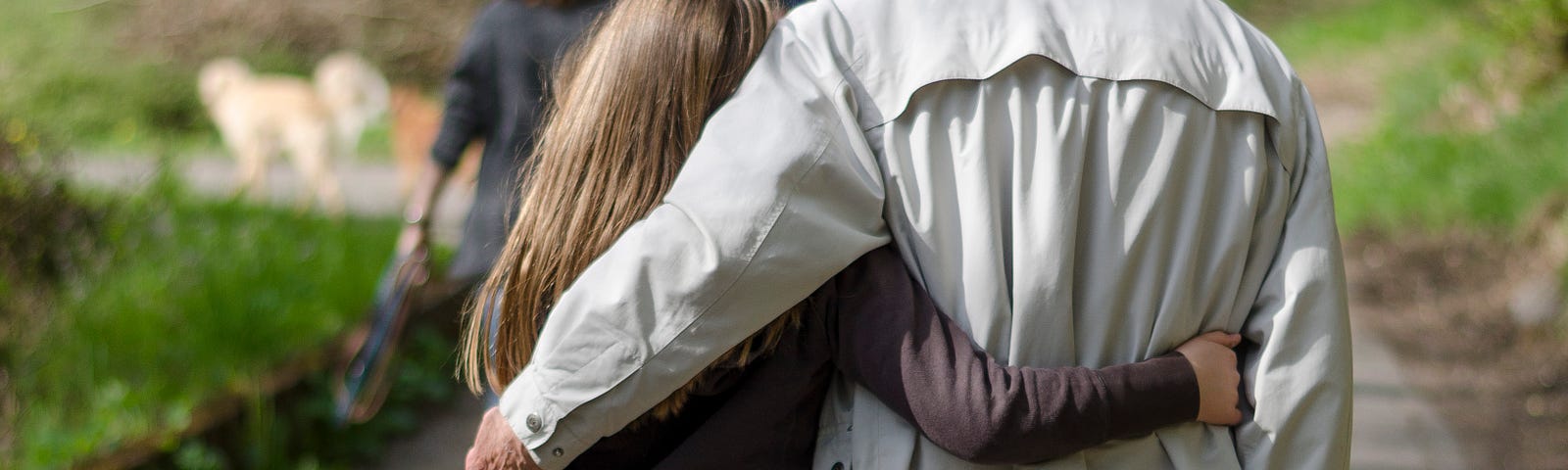 Father and daughter hugging and taking a walk in the park.