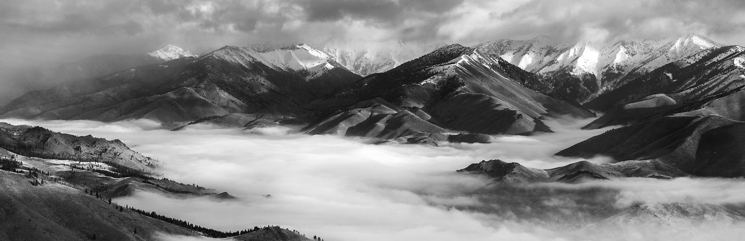 black and white landscape of misty mountains