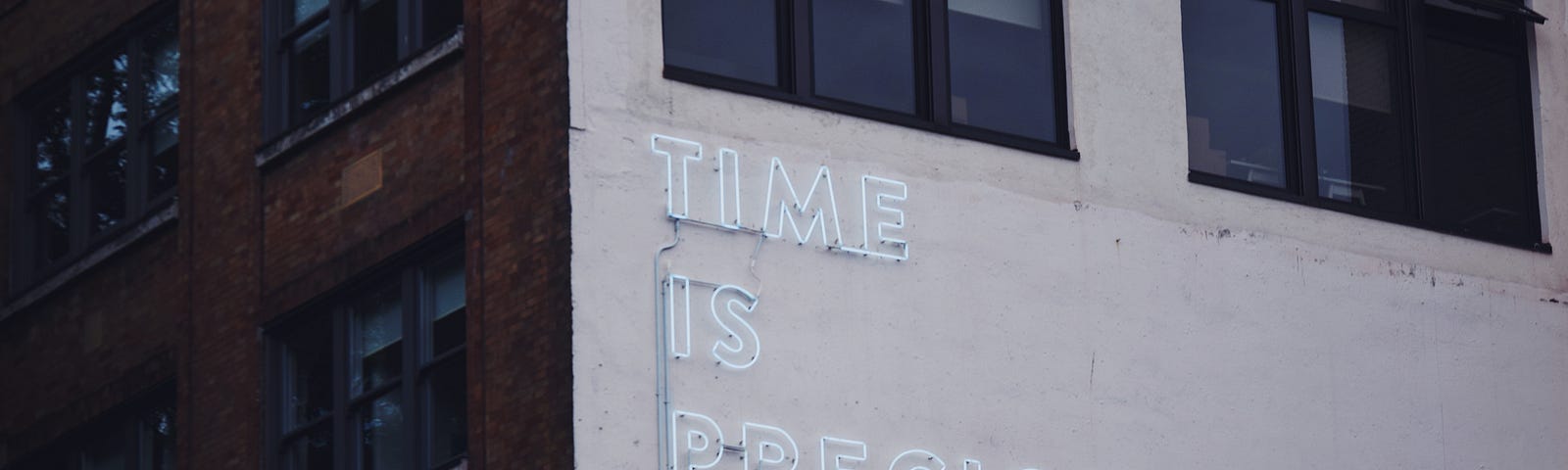 Neon lights spelling the phrase, “Time is Precious”