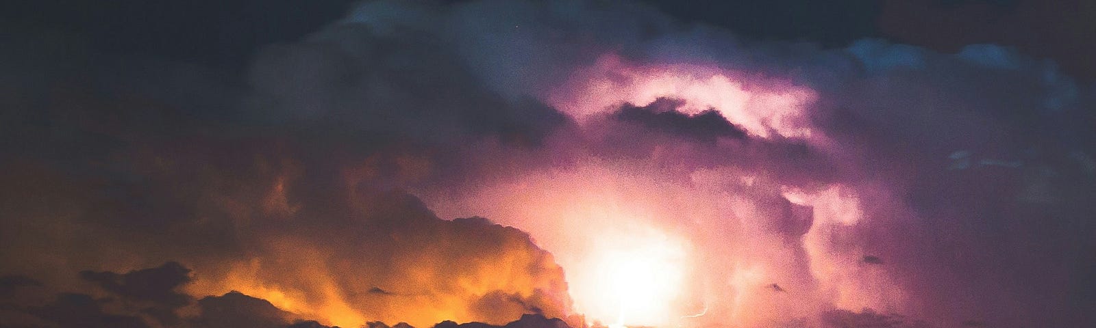 Photograph of lightning with dark clouds.