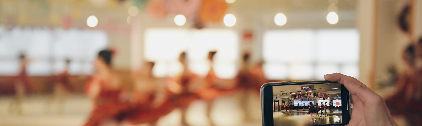 dancers standing are recorded on a phone