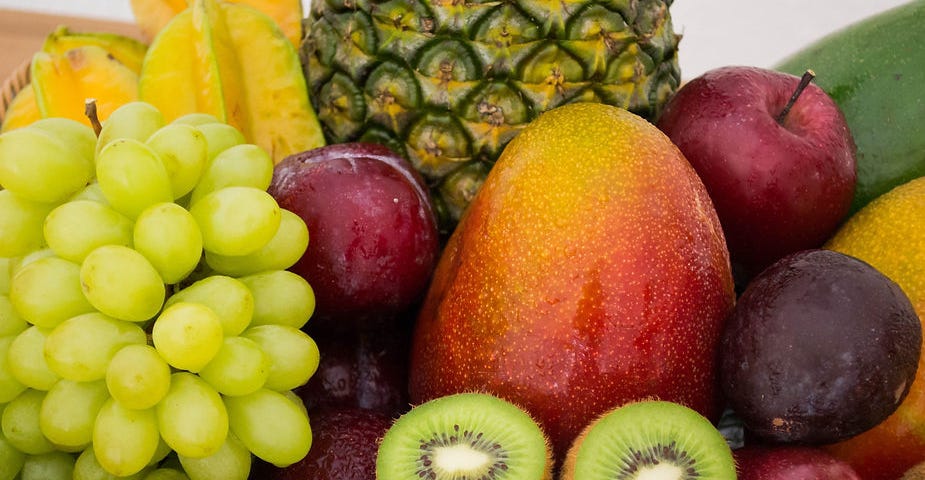 A basket of fresh fruit sitting on the table.