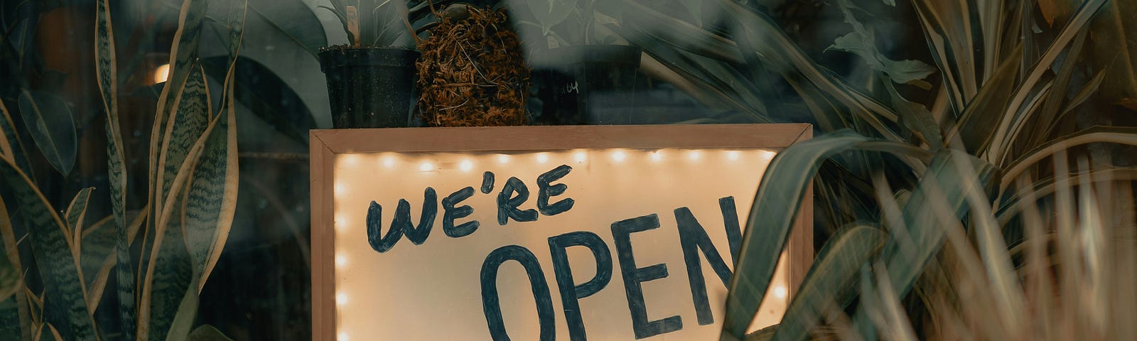 “We are open” sign in a shop window.