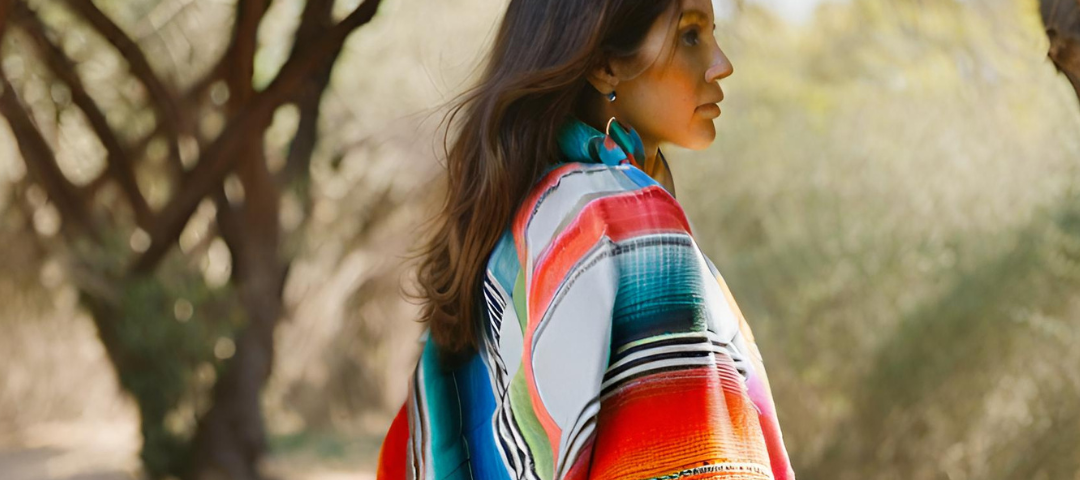 Image of a woman in a colorful poncho