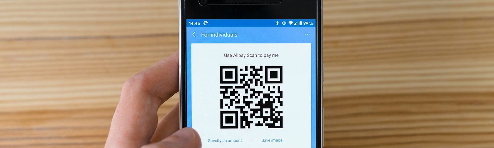 A smartphone with a QR code payment option showing on the screen.