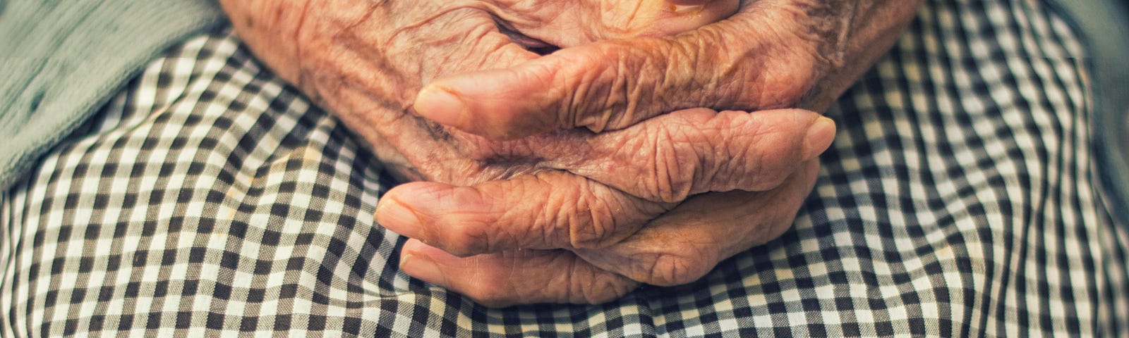 An old person’s hands clasped
