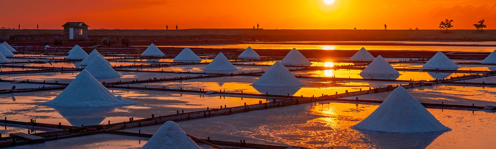 piles of salt at sunset