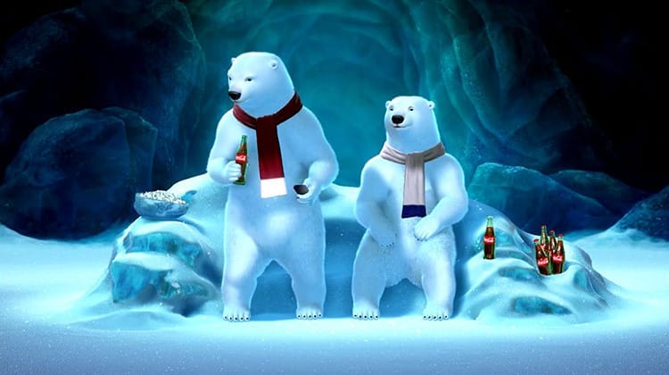 Coca Cola advertisement, with 2 polar bears wearing scarfs, next to bottles of Cola