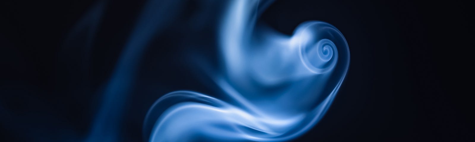 This is a photo of a swirling object that is blue on a black background