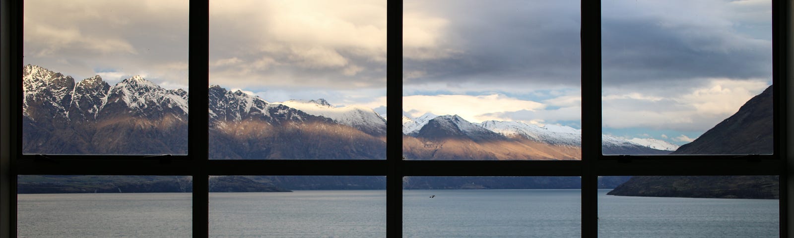 A window view with lake in the mountains