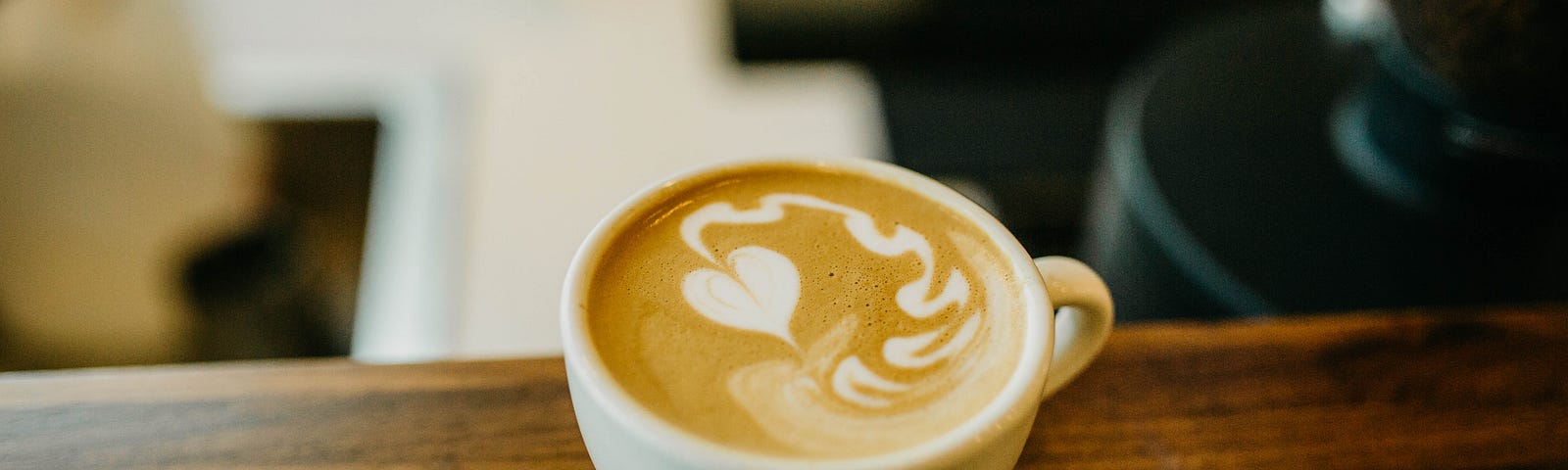 a cup of coffee with heart foam