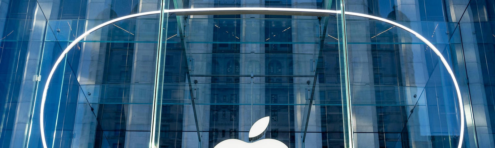 A Vision Pro shaped symbol on a glass Apple Store