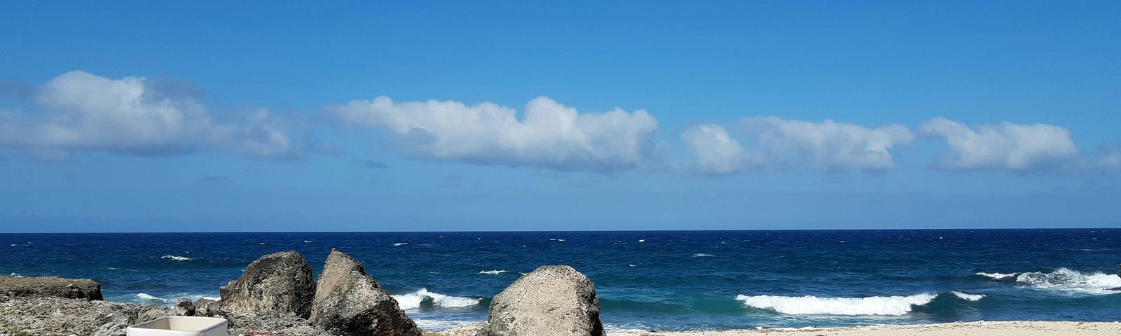 A solitary toilet on a tranquil beach, symbolizing the unexpected places where mindfulness can be practiced.