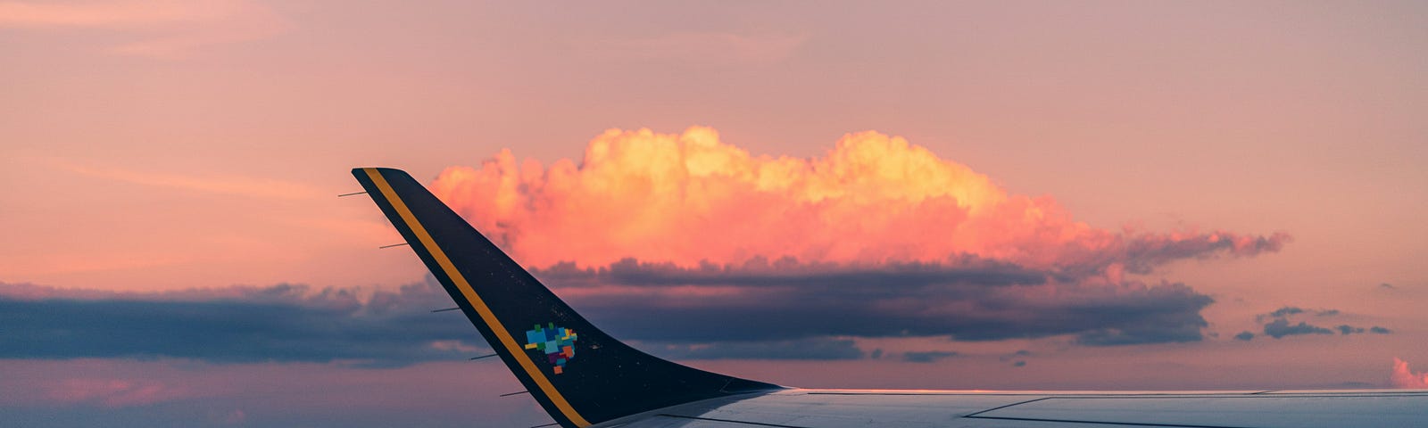 Wing of a commercial airplane at sunset