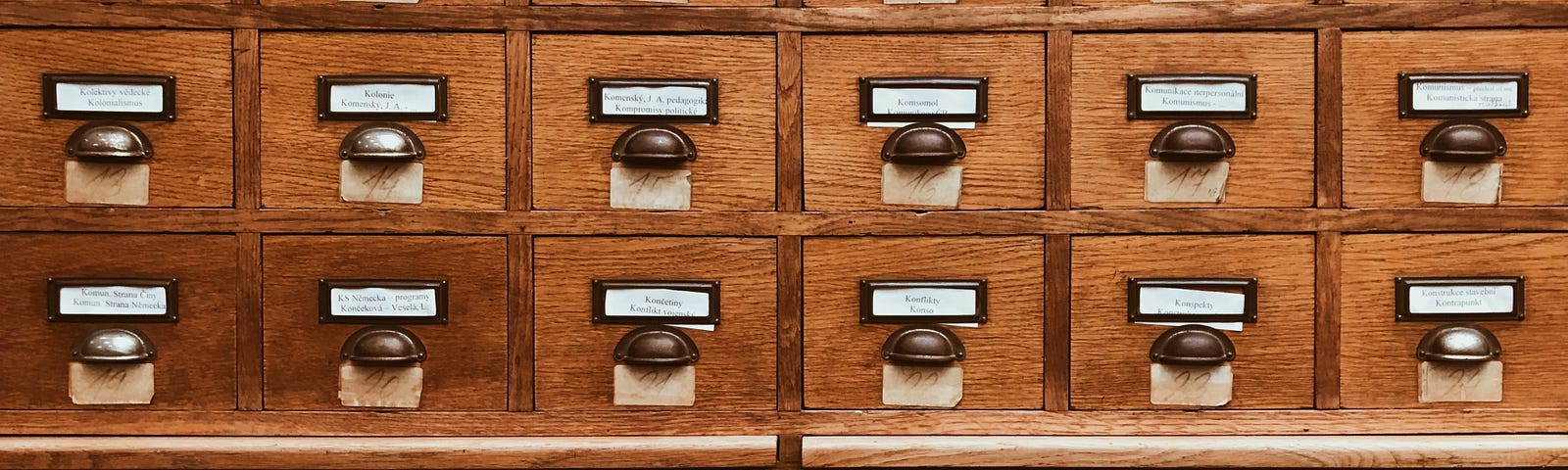 A file cabinet with small compartments of drawers