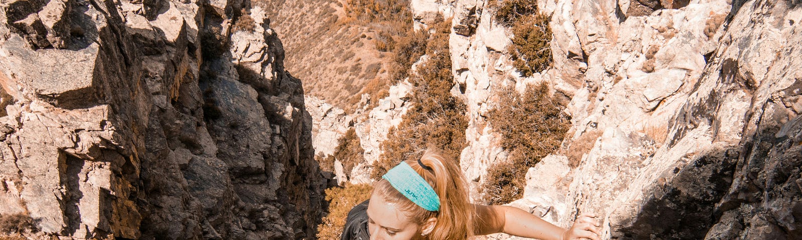 woman climbing up a montain