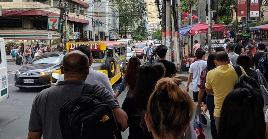 Image of people on a busy street of a city in the Philippines