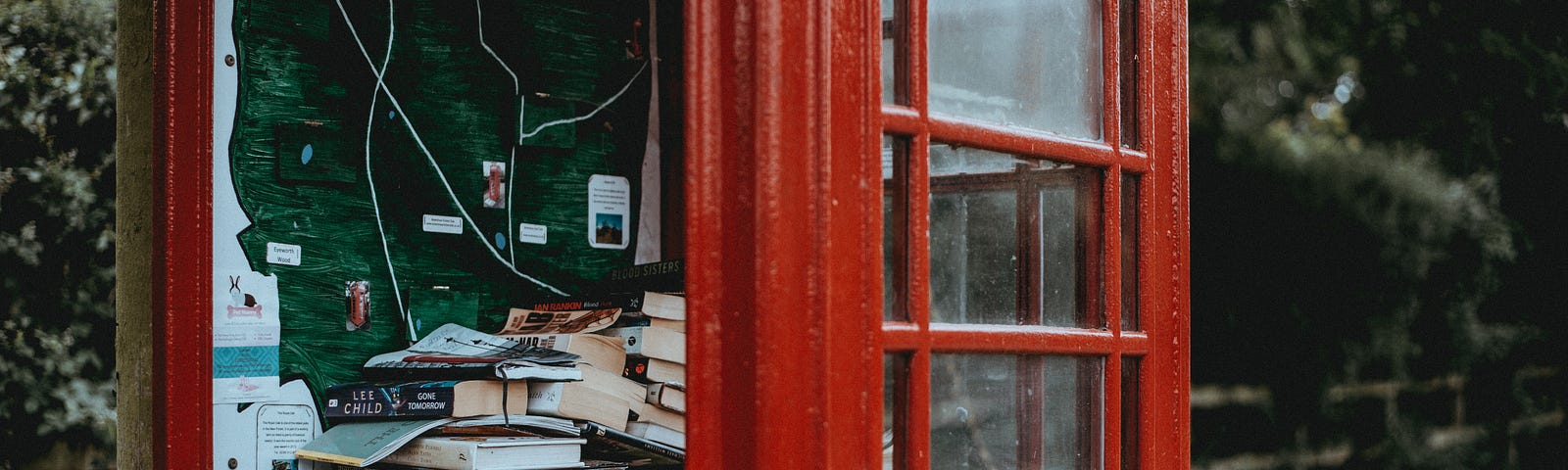 A British phone cabin filled with books, like a bookshelf.