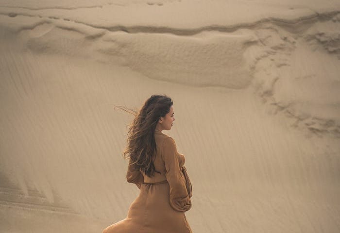 Young woman walking in desert