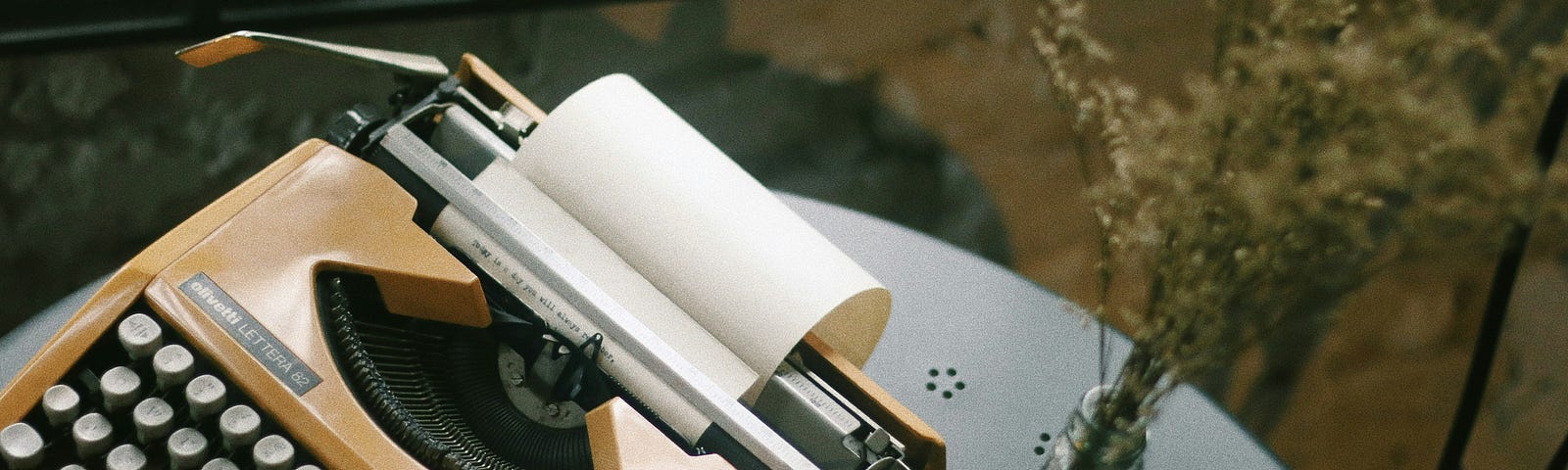 A gold typewriter on a small table.