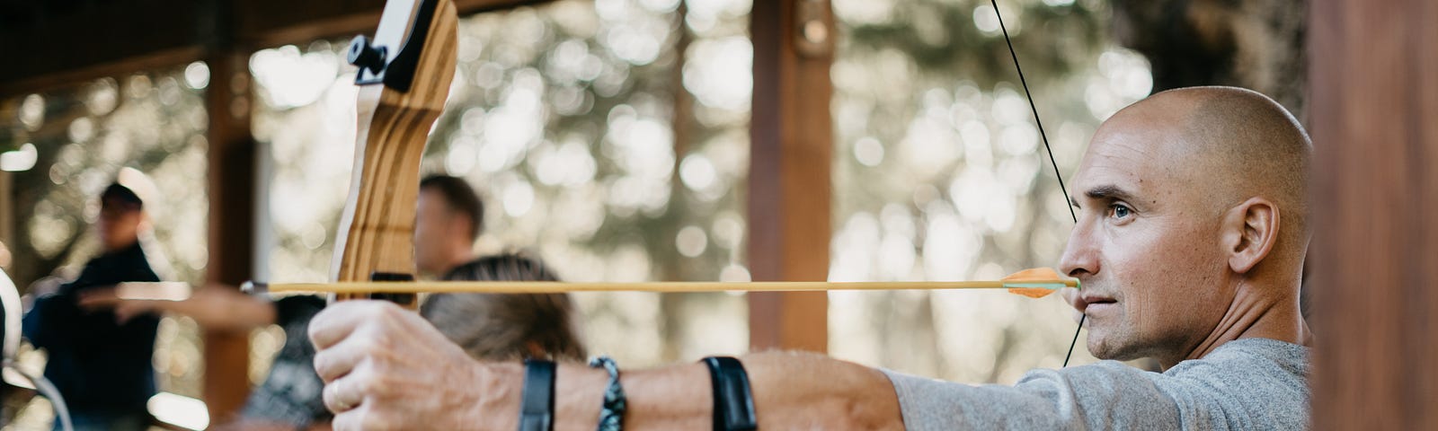 Man aiming bow and arrow.