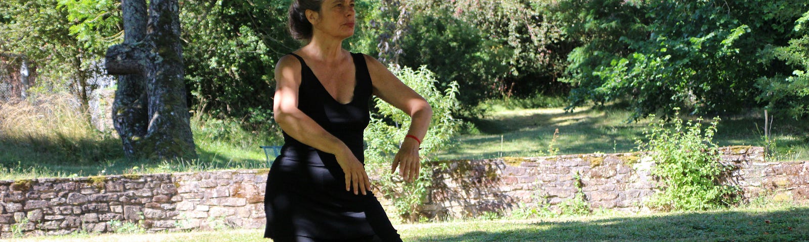 A lady doing Tai Chi in the park.