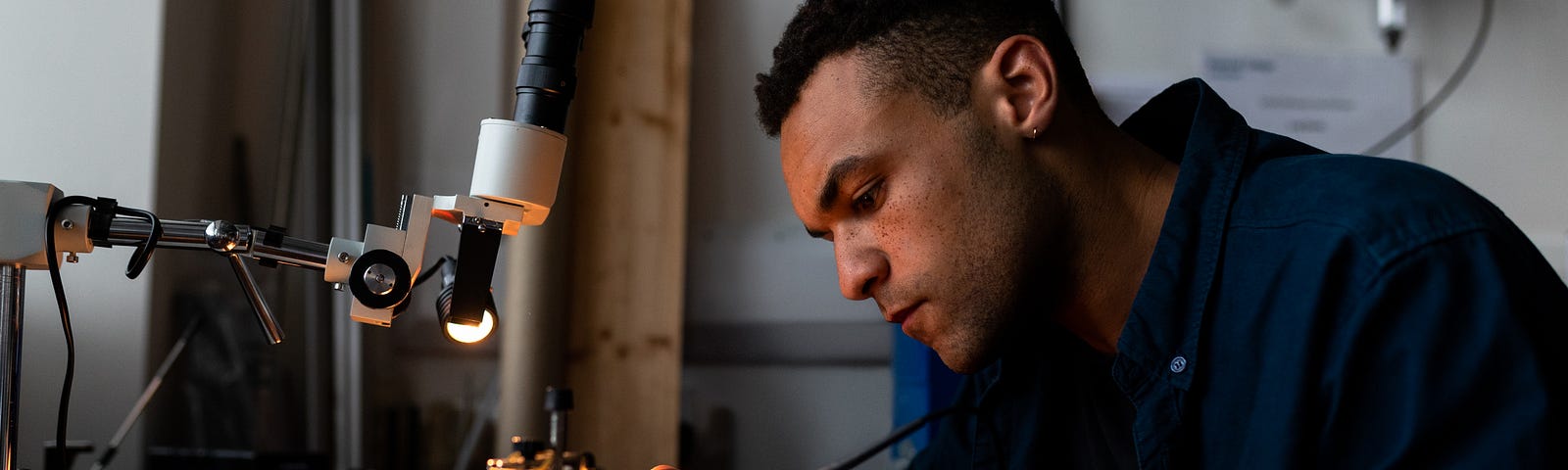 Male mechanical engineer solders parts for prosthetic limbs