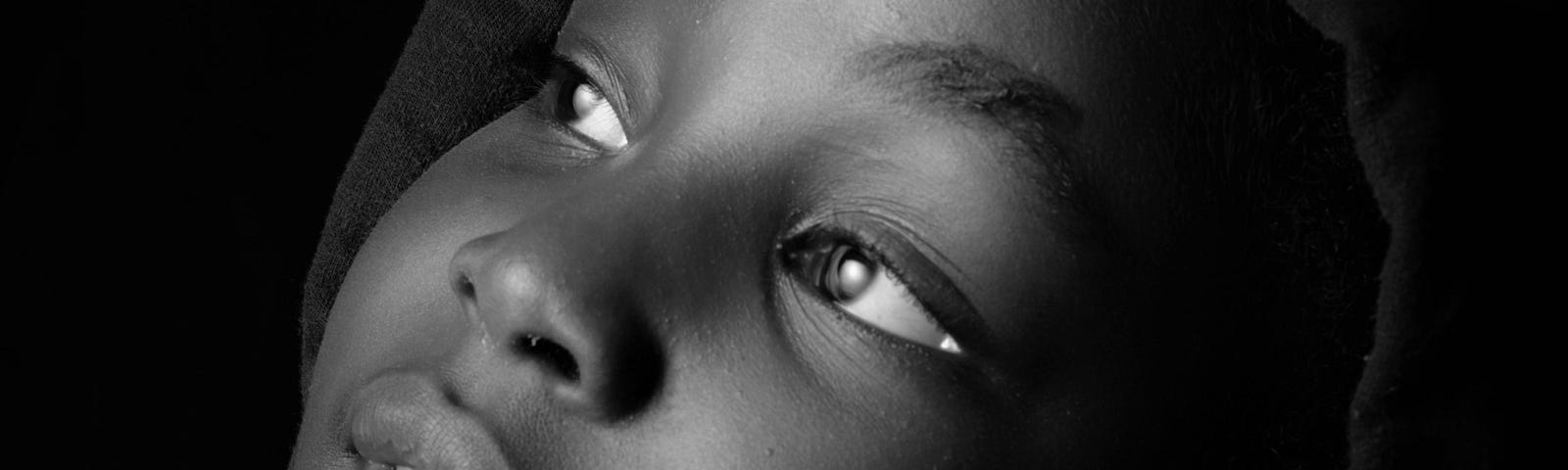 Beautiful child. African. Looking upwards. In black and white. A young mind looks always up.