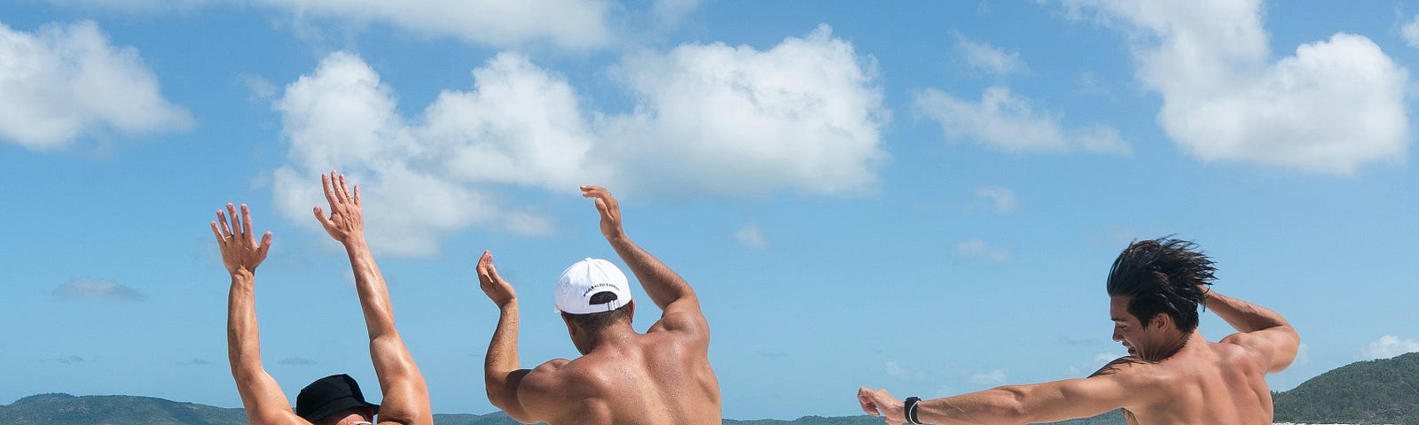 Three guys just starting their vacation in Jamaica and they’re happy to be on the beach.