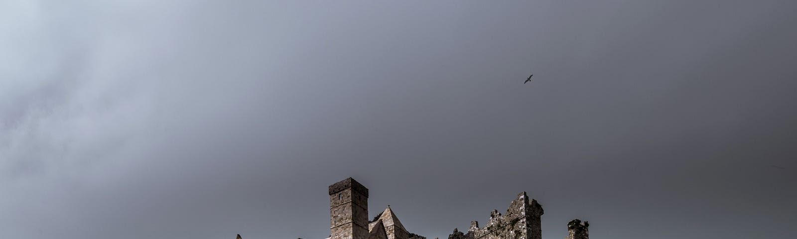 grey scene with a castle on a hill