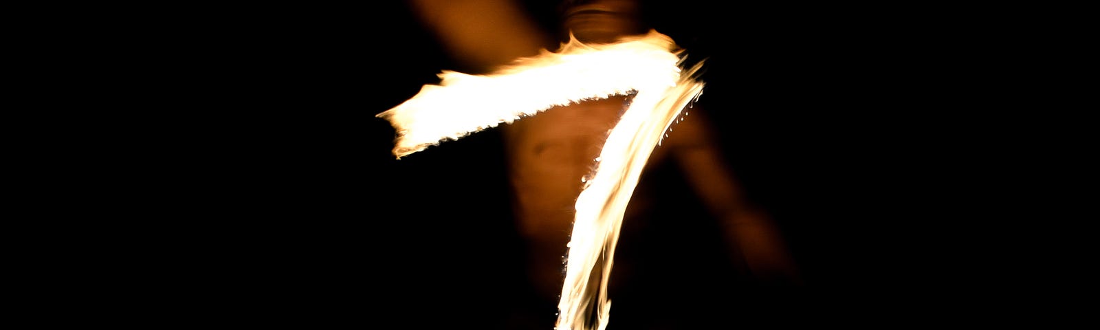 The number 7 appears to be made of controlled flames. A blurred person is in the background against a black background. There are 7 lifestyle maneuvers that can lower colorectal cancer risk.