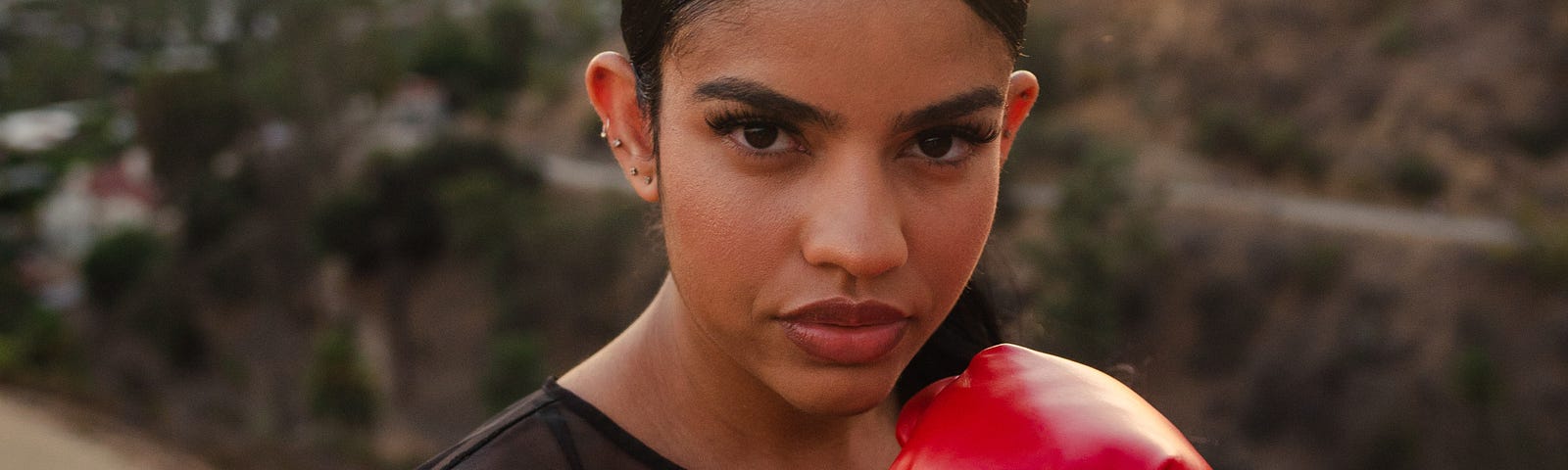 A powerful woman boxing with red cloves